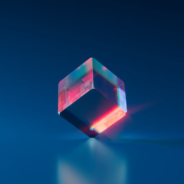 a crystal cube standing on one corner, resting on a glass-like surface